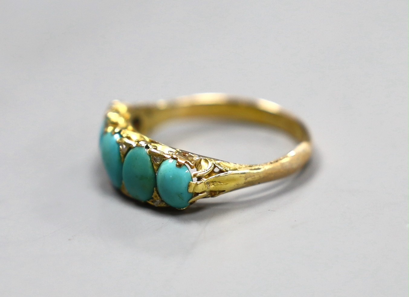 An 18ct gold turquoise set five stone half hoop ring with diamond chip intersections, size R, gross 3.5 grams